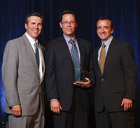 Geotech President and CEO (center) accepts award